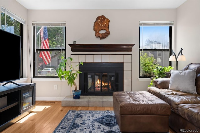 4691 S Fraser Cir Unit A, Aurora, CO 80015 - living room with wood finished floors and a tiled fireplace