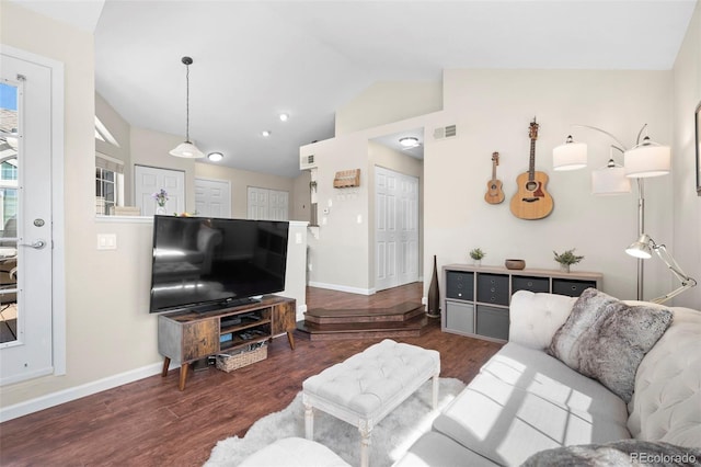 living area with lofted ceiling, wood finished floors, and baseboards