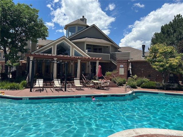 community pool with a patio and fence