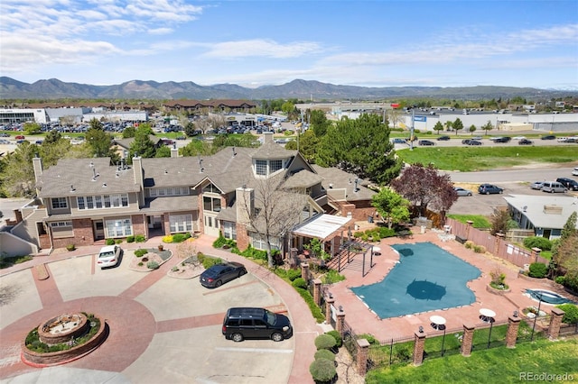 bird's eye view of a mountain backdrop and a pool