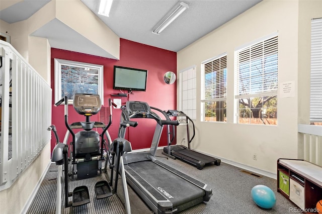 workout room with carpet flooring and baseboards