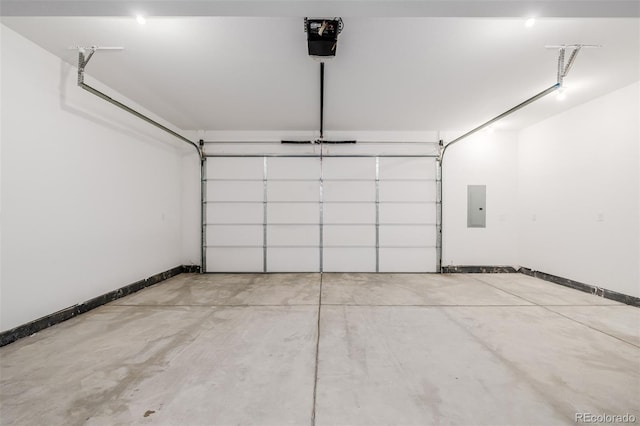 garage featuring electric panel, baseboards, and a garage door opener