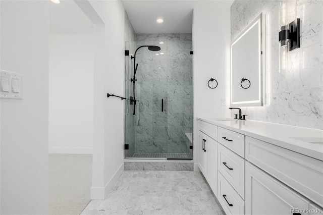 bathroom with marble finish floor, recessed lighting, vanity, and a marble finish shower