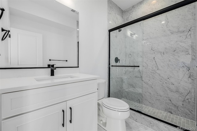 full bathroom with toilet, a marble finish shower, and vanity