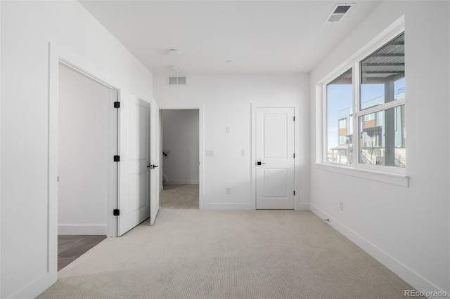 unfurnished bedroom with visible vents, baseboards, and carpet floors