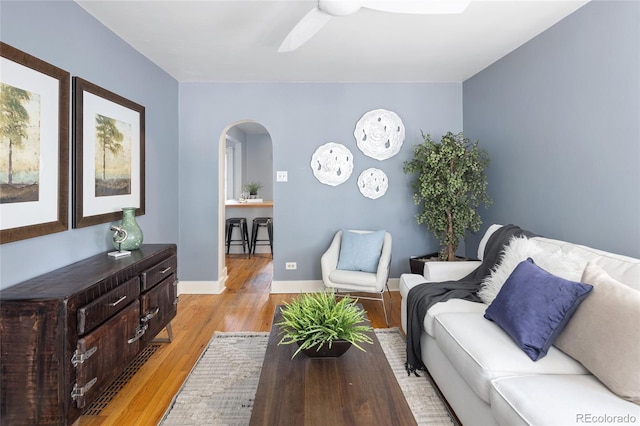 1838 S Williams St, Denver, CO 80210 - living room featuring arched walkways, light wood-style flooring, and a ceiling fan