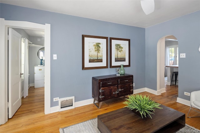 1838 S Williams St, Denver, CO 80210 - living area featuring arched walkways and light wood finished floors