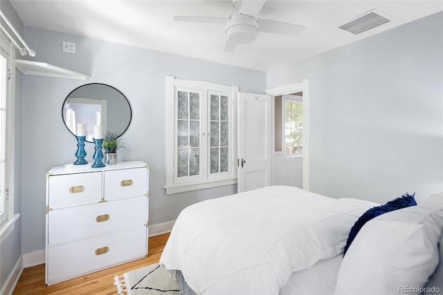 1838 S Williams St, Denver, CO 80210 - bedroom with light wood finished floors and ceiling fan