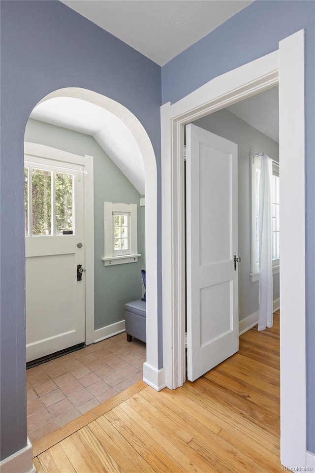 1838 S Williams St, Denver, CO 80210 - foyer featuring arched walkways, lofted ceiling, and light wood-style flooring