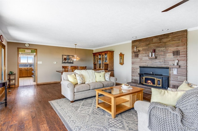 12891 County Road 29, Sterling, CO 80751 - living area with wood finished floors, crown molding, a stone fireplace, and a ceiling fan