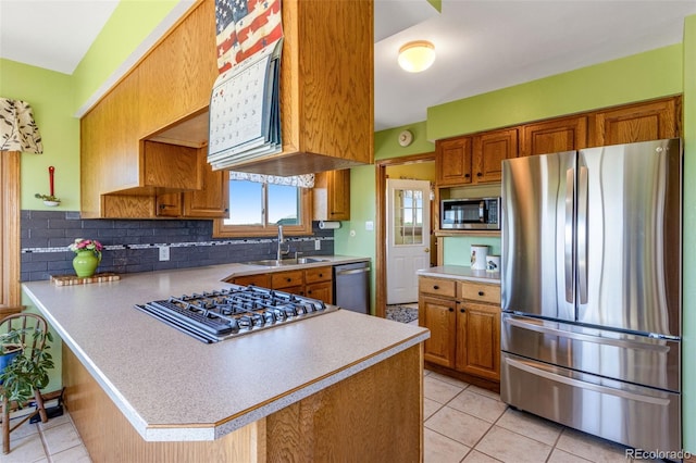 12891 County Road 29, Sterling, CO 80751 - kitchen with stainless steel appliances, light countertops, a peninsula, and light tile patterned flooring