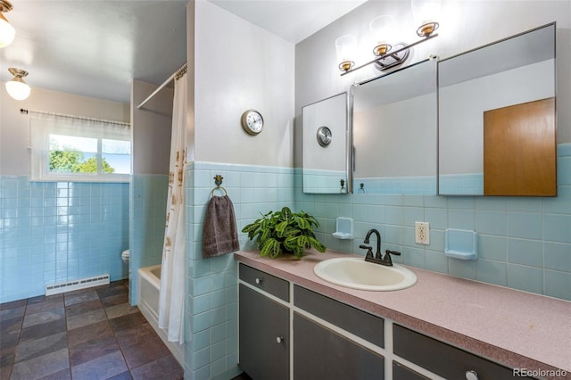 12891 County Road 29, Sterling, CO 80751 - full bath with vanity, shower / bath combo, tile walls, and wainscoting