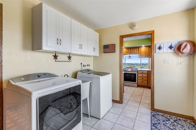 12891 County Road 29, Sterling, CO 80751 - laundry room with cabinet space, independent washer and dryer, and light tile patterned floors