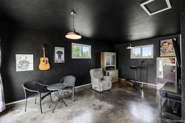 12891 County Road 29, Sterling, CO 80751 - sitting room featuring concrete floors, healthy amount of natural light, and a textured ceiling