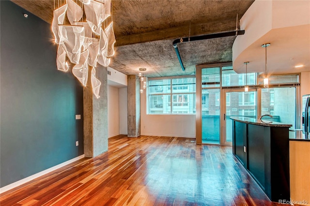 interior space with hanging light fixtures and hardwood / wood-style flooring