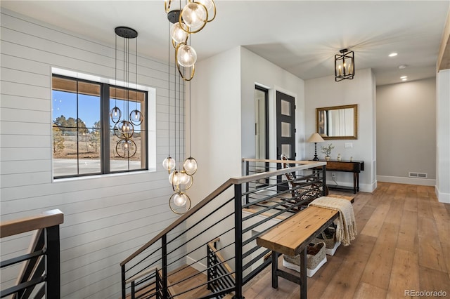 interior space featuring an inviting chandelier and hardwood / wood-style flooring