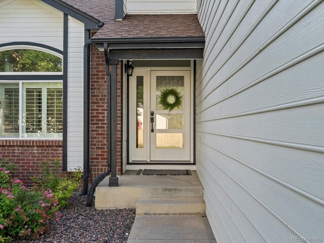 12695 Wolff St, Broomfield, CO 80020 - property entrance featuring brick siding and roof with shingles