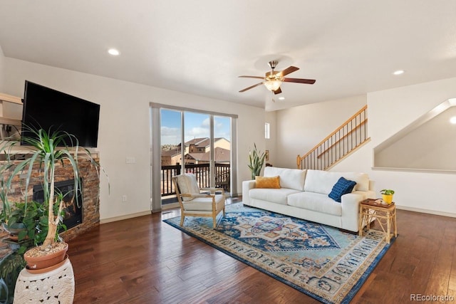 living room with baseboards, a ceiling fan, wood finished floors, a lit fireplace, and recessed lighting