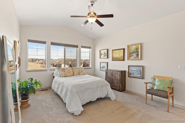 bedroom with light carpet, ceiling fan, baseboards, and vaulted ceiling