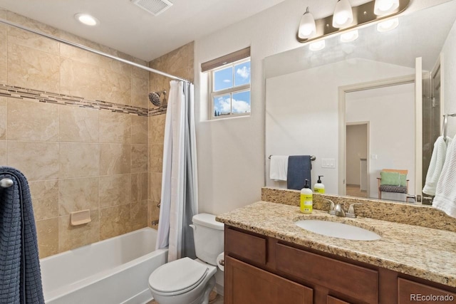 bathroom featuring toilet, visible vents, shower / bath combination with curtain, and vanity