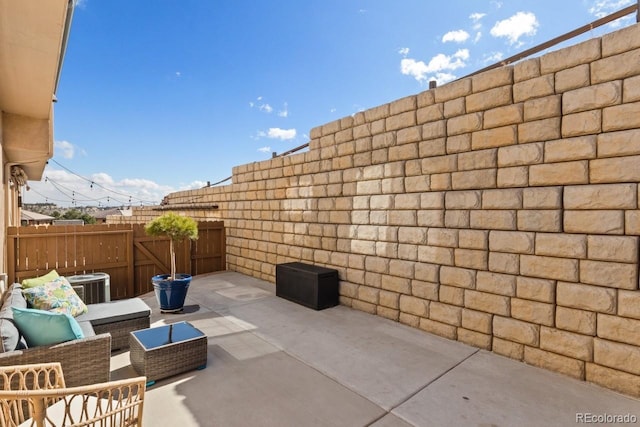 view of patio with fence and central AC