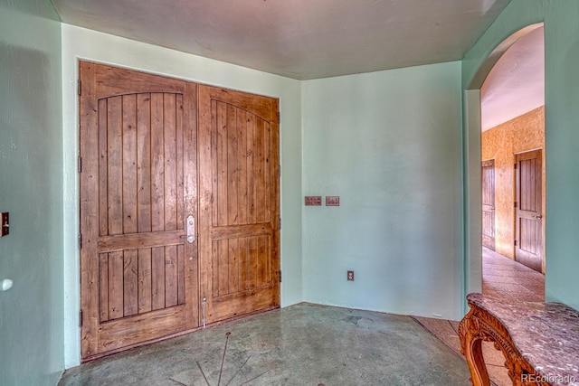 unfurnished bedroom with concrete floors