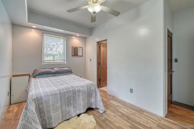 bedroom featuring ceiling fan and light hardwood / wood-style flooring