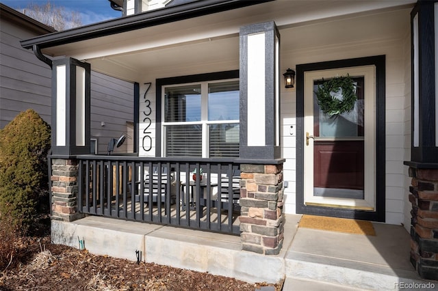 view of exterior entry with covered porch