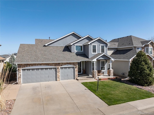 craftsman inspired home with concrete driveway, stucco siding, stone siding, an attached garage, and a front lawn