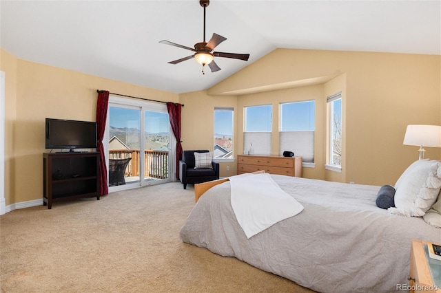 carpeted bedroom featuring access to exterior, vaulted ceiling, and a ceiling fan