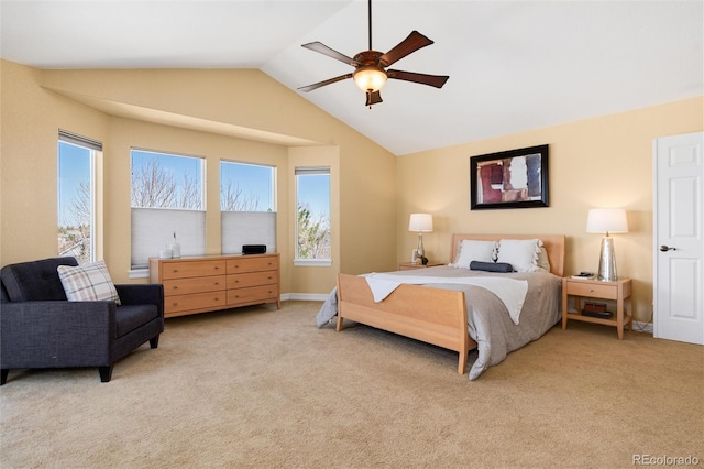bedroom with ceiling fan, light colored carpet, and vaulted ceiling