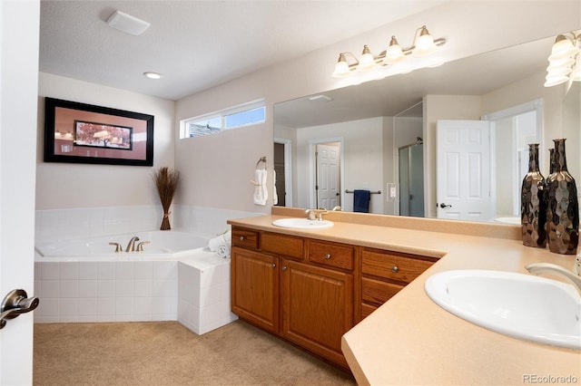 full bathroom featuring a sink, a shower stall, double vanity, and a garden tub