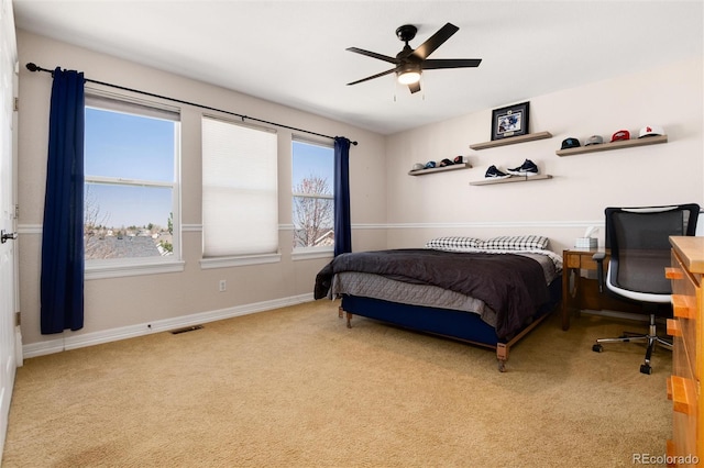 bedroom with visible vents, baseboards, a ceiling fan, and carpet floors