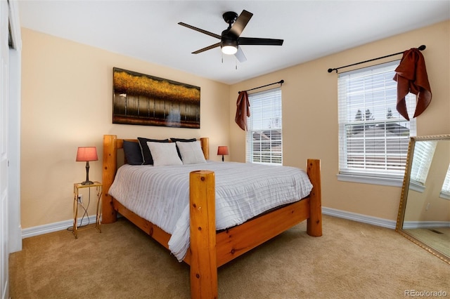 bedroom featuring ceiling fan, baseboards, and carpet floors