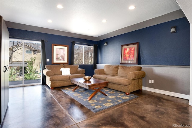living area with concrete floors, recessed lighting, and plenty of natural light