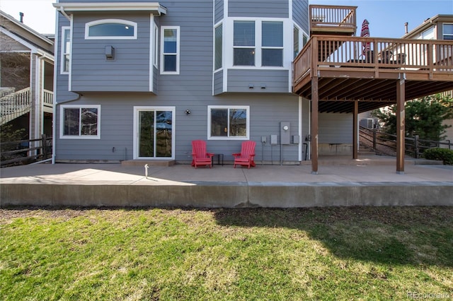 back of house with a patio, a deck, and a lawn