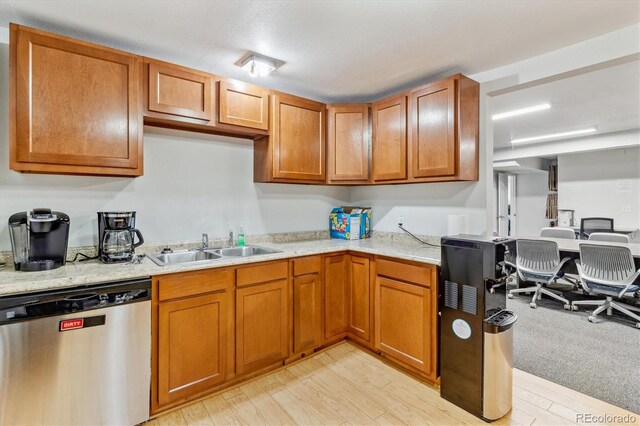 1050 S Quitman St, Denver, CO 80219 - kitchen featuring dishwasher, brown cabinets, a sink, and light wood finished floors