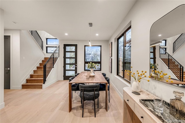 dining space with light wood-type flooring and plenty of natural light