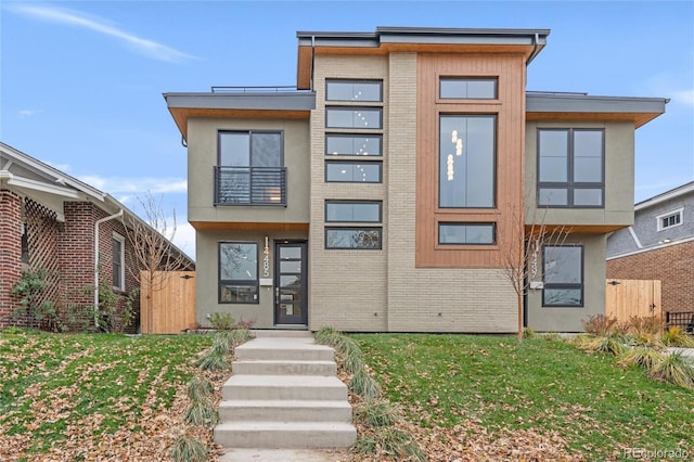 contemporary home with a front lawn