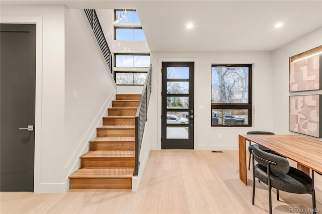 entrance foyer featuring light hardwood / wood-style flooring and a healthy amount of sunlight