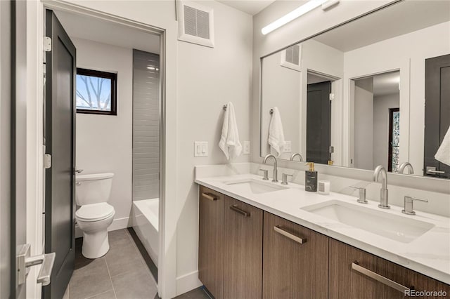 full bathroom featuring tile patterned floors, vanity, toilet, and washtub / shower combination