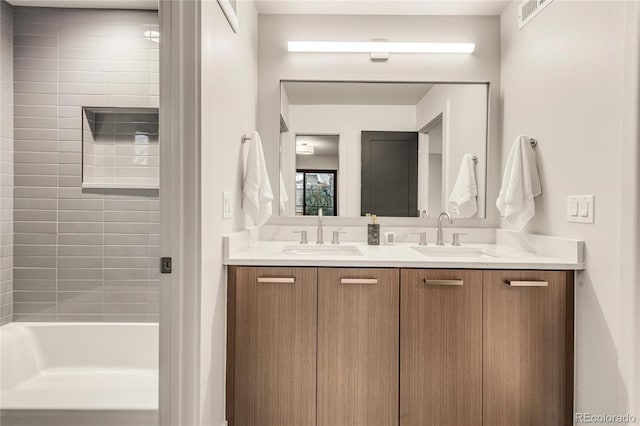 bathroom with vanity and tiled shower / bath combo