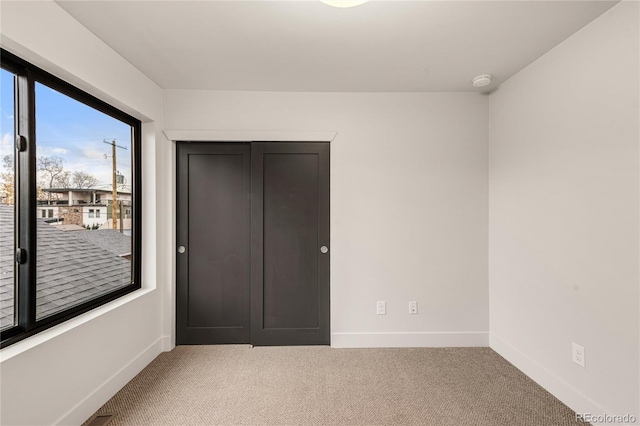 unfurnished bedroom featuring carpet and a closet