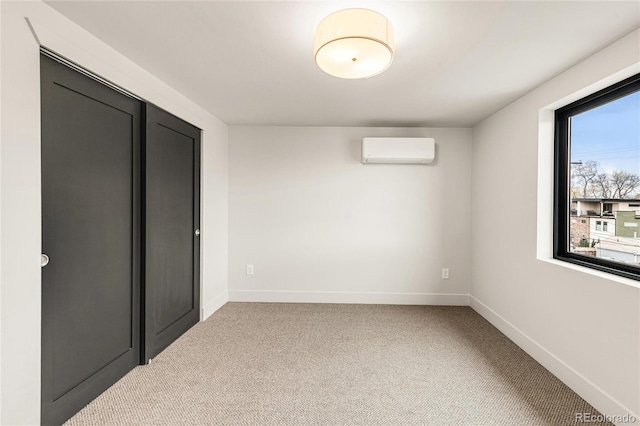 spare room with carpet flooring and a wall mounted air conditioner