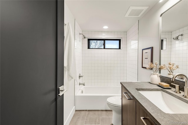 full bathroom featuring vanity, toilet, and tiled shower / bath