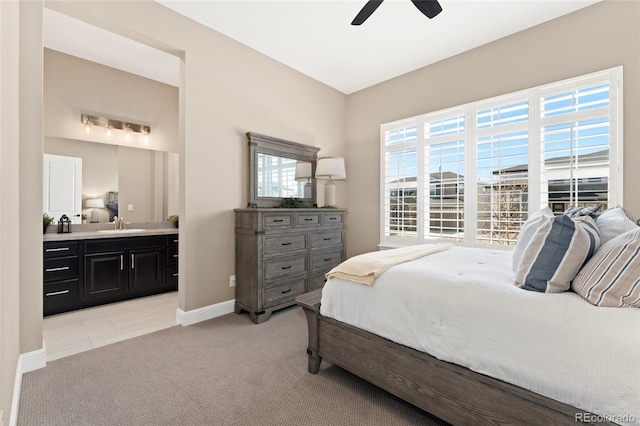 228 Rogers Ct, Castle Rock, CO 80104 - bedroom featuring light colored carpet, a sink, ensuite bath, baseboards, and ceiling fan
