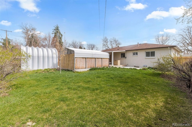 3055 S Winona Ct, Denver, CO 80236 - view of yard featuring an outdoor structure, fence, and a storage shed