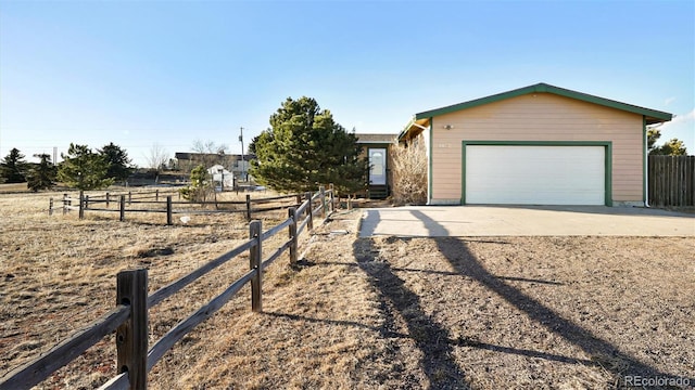 ranch-style home featuring a garage and an outbuilding