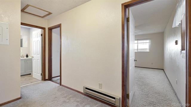 hall featuring light carpet, a textured ceiling, baseboard heating, and electric panel