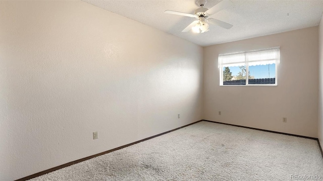 carpeted spare room with ceiling fan and a textured ceiling